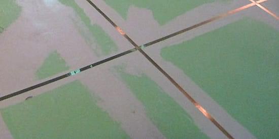 A network of conducting copper tape can be used to ground new ESD control flooring systems. "A network of conducting copper tape can be used to ground new ESD control flooring systems."